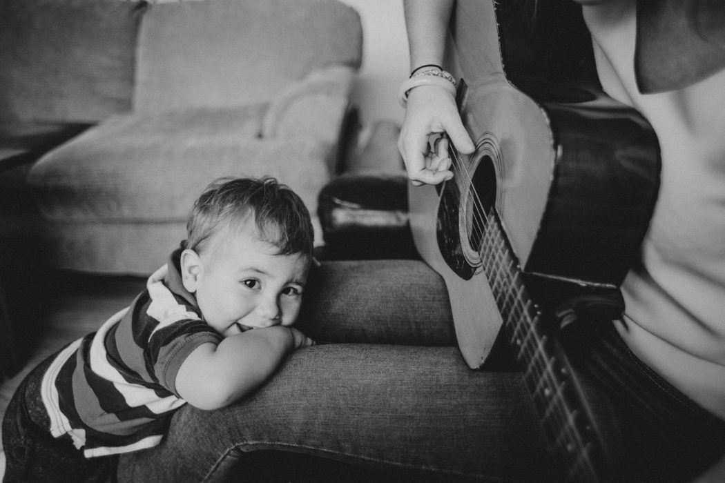 Baby listening to guitar