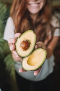 woman with open avocado