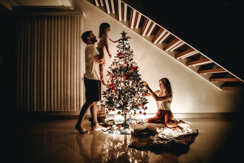 family putting up christmas tree